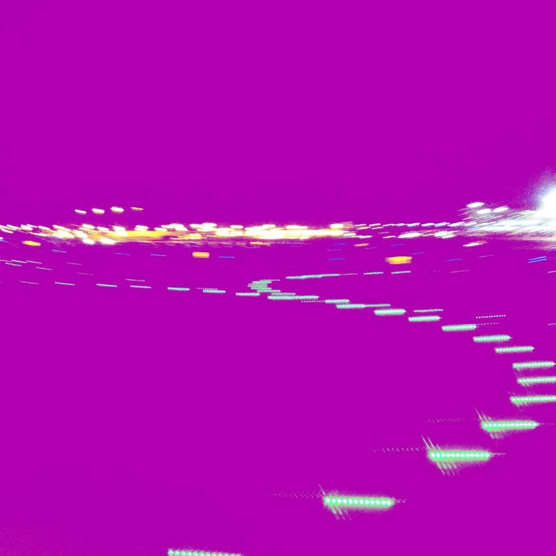 Image of lights on airport tarmac at night, colors inverted.